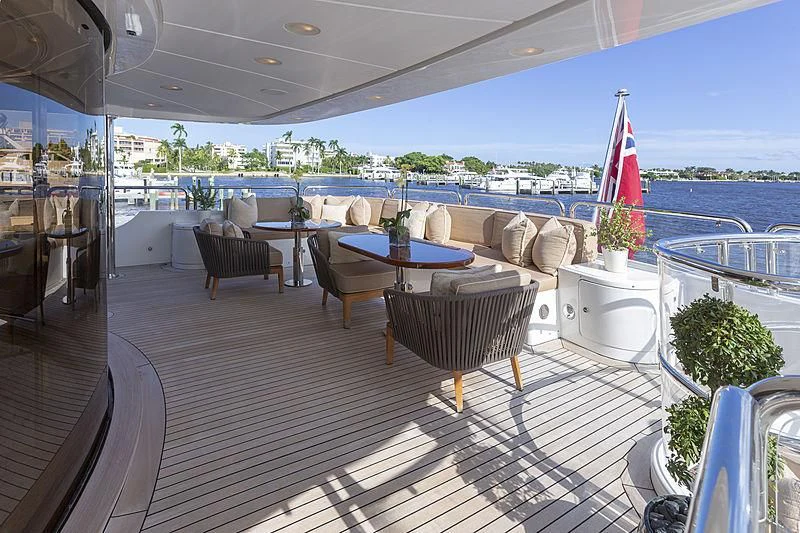 a deck with a table and chairs aboard GROOVER Yacht for Sale