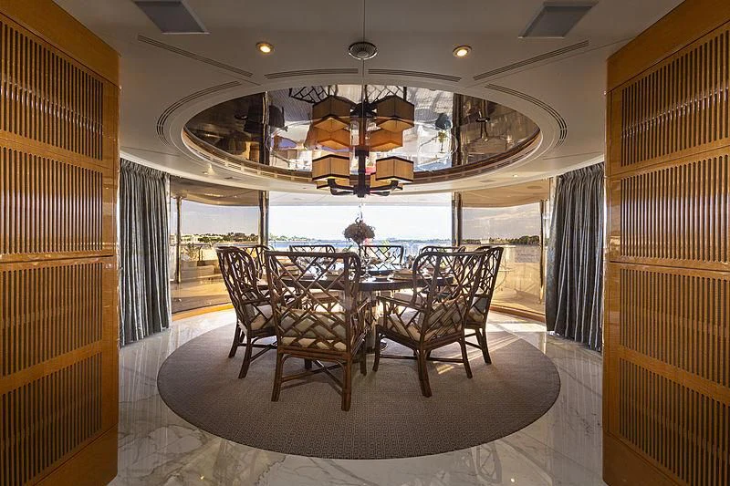 a dining room with a chandelier aboard GROOVER Yacht for Sale