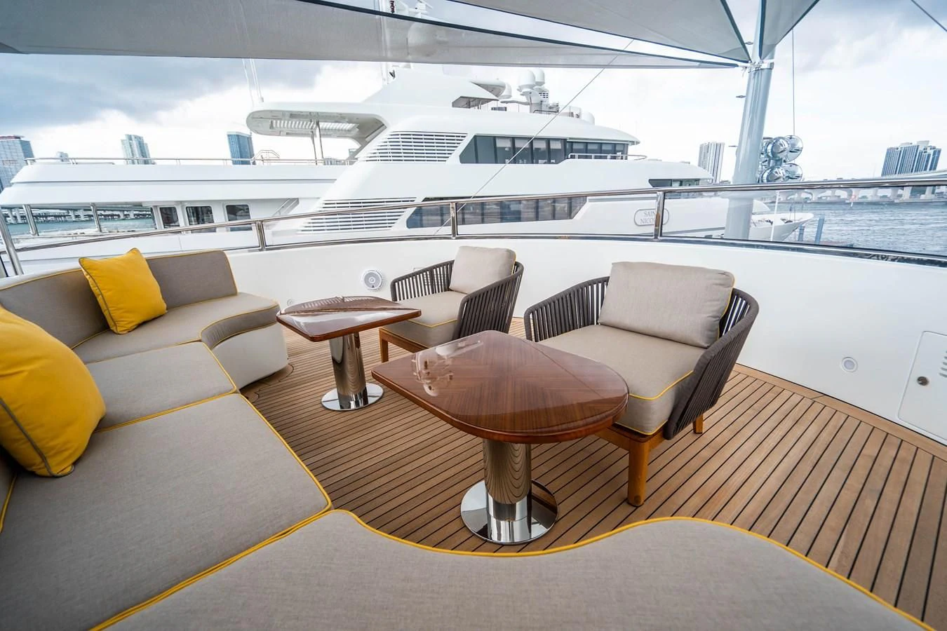 a room with a table chairs and a large cruise ship in the background aboard GROOVER Yacht for Sale