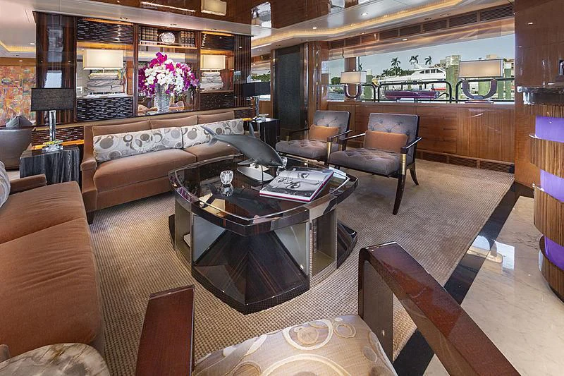 a living room with a large glass coffee table aboard GROOVER Yacht for Sale