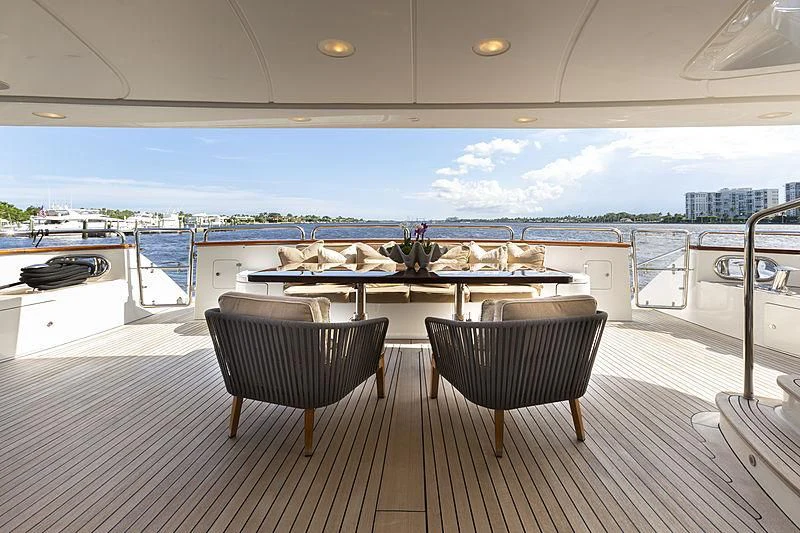 a table and chairs on a deck overlooking a body of water aboard GROOVER Yacht for Sale