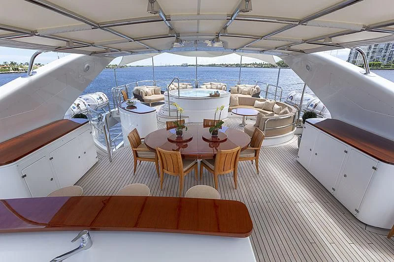 a boat with tables and chairs aboard GROOVER Yacht for Sale
