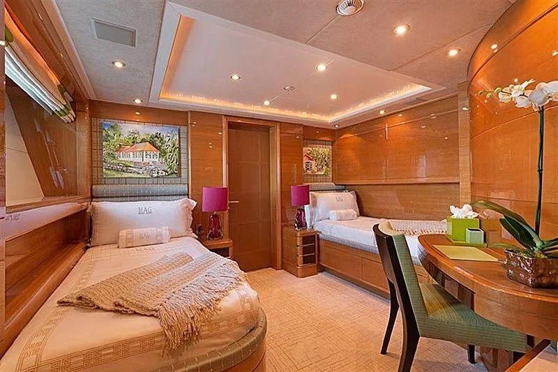 a room with a bed and a table aboard GROOVER Yacht for Sale