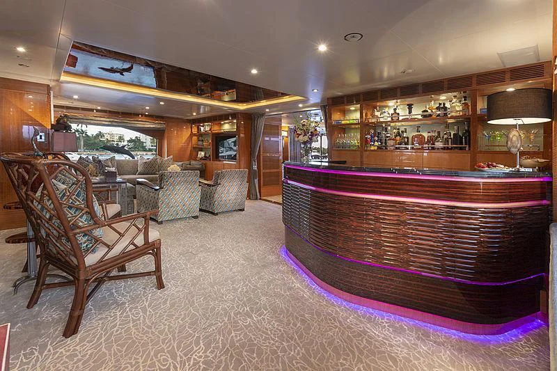 a large room with a large purple rug and a chair aboard GROOVER Yacht for Sale