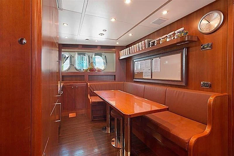 a room with a table and chairs aboard GROOVER Yacht for Sale