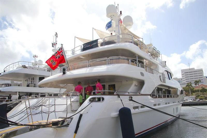 a large white boat with a flag on it aboard GROOVER Yacht for Sale