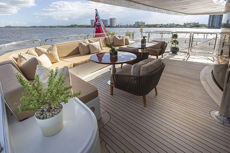a deck with a table and chairs on it aboard GROOVER Yacht for Sale