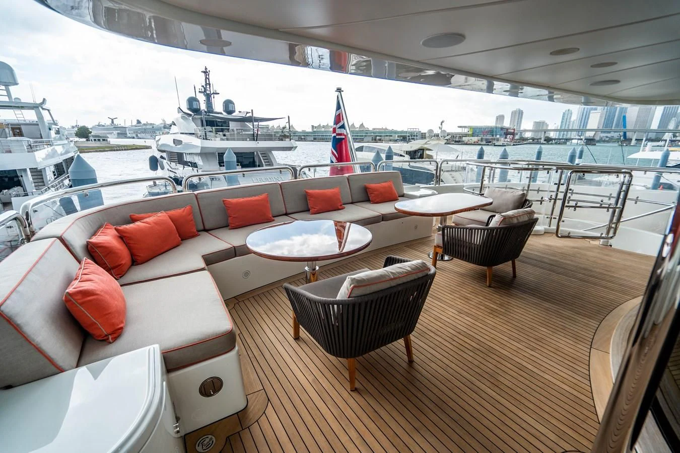 a room with a table chairs and a boat in the water aboard GROOVER Yacht for Sale