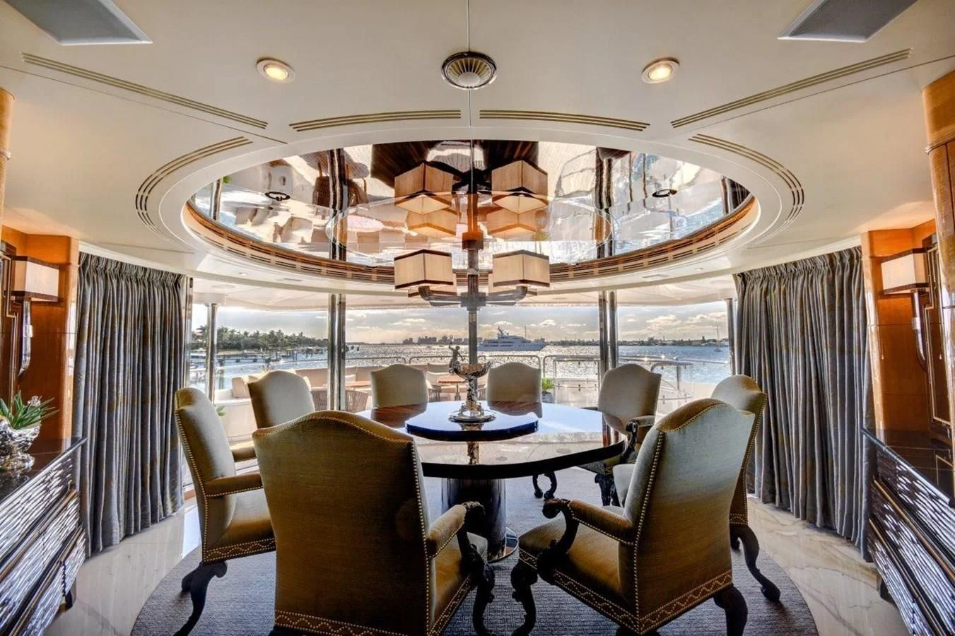 a room with a table chairs and a chandelier aboard GROOVER Yacht for Sale