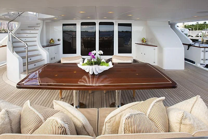 a living room with a table and couches aboard GROOVER Yacht for Sale