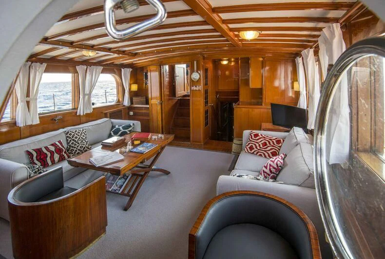 a living room with a couch and a table aboard SEA PRINCE Yacht for Sale