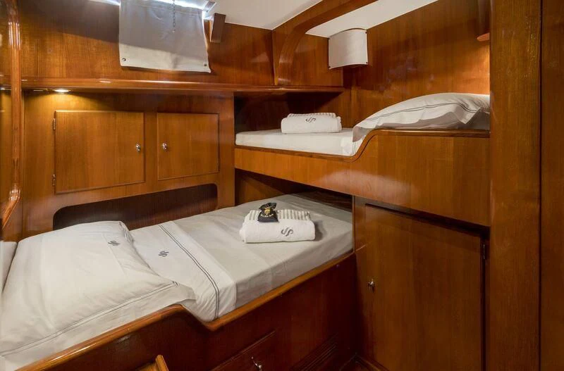 a bed with a white pillow aboard SEA PRINCE Yacht for Sale