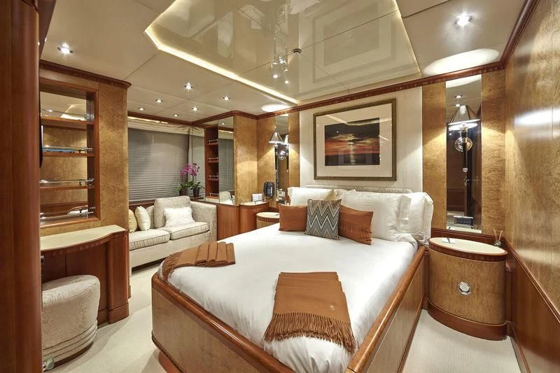 a room with a bed and a mirror aboard AZUL V Yacht for Charter