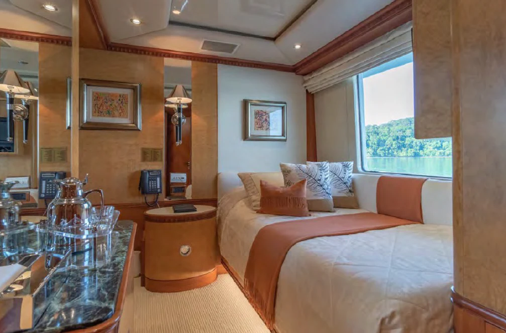 a hotel room with a bed and a table aboard AZUL V Yacht for Charter