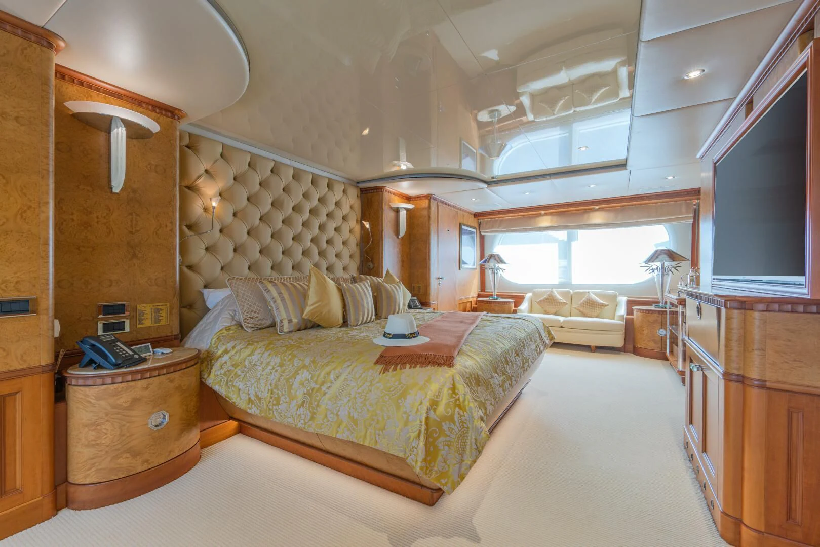 a bedroom with a bed and a dresser aboard AZUL V Yacht for Charter