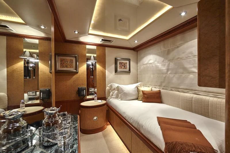 a room with a bed and a mirror aboard AZUL V Yacht for Charter