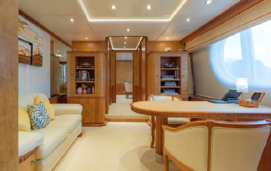 a living room with a table and couches aboard AZUL V Yacht for Charter