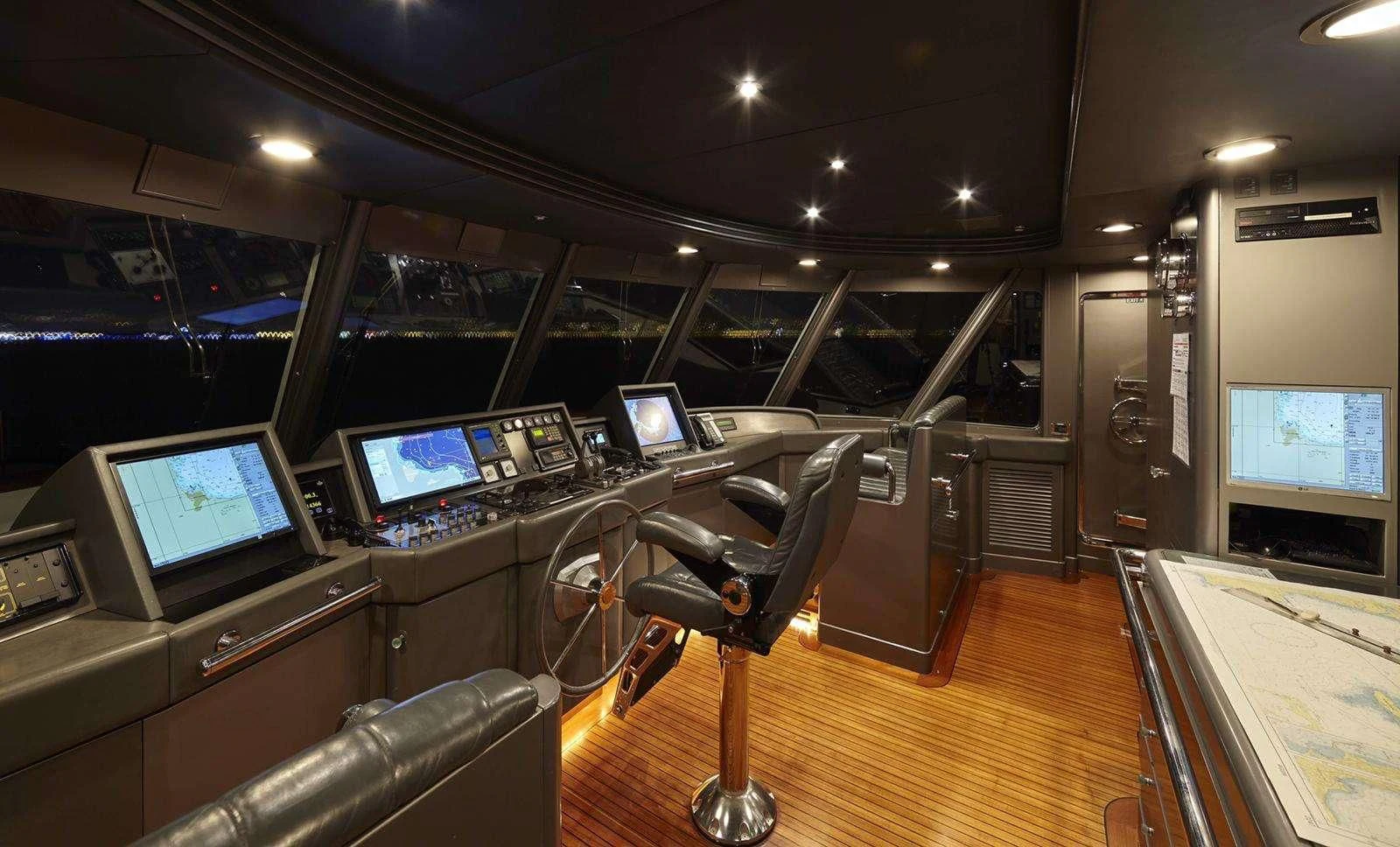 a room with computers and monitors aboard AZUL V Yacht for Charter