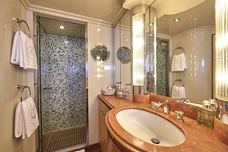a bathroom with a sink and a mirror aboard AZUL V Yacht for Charter
