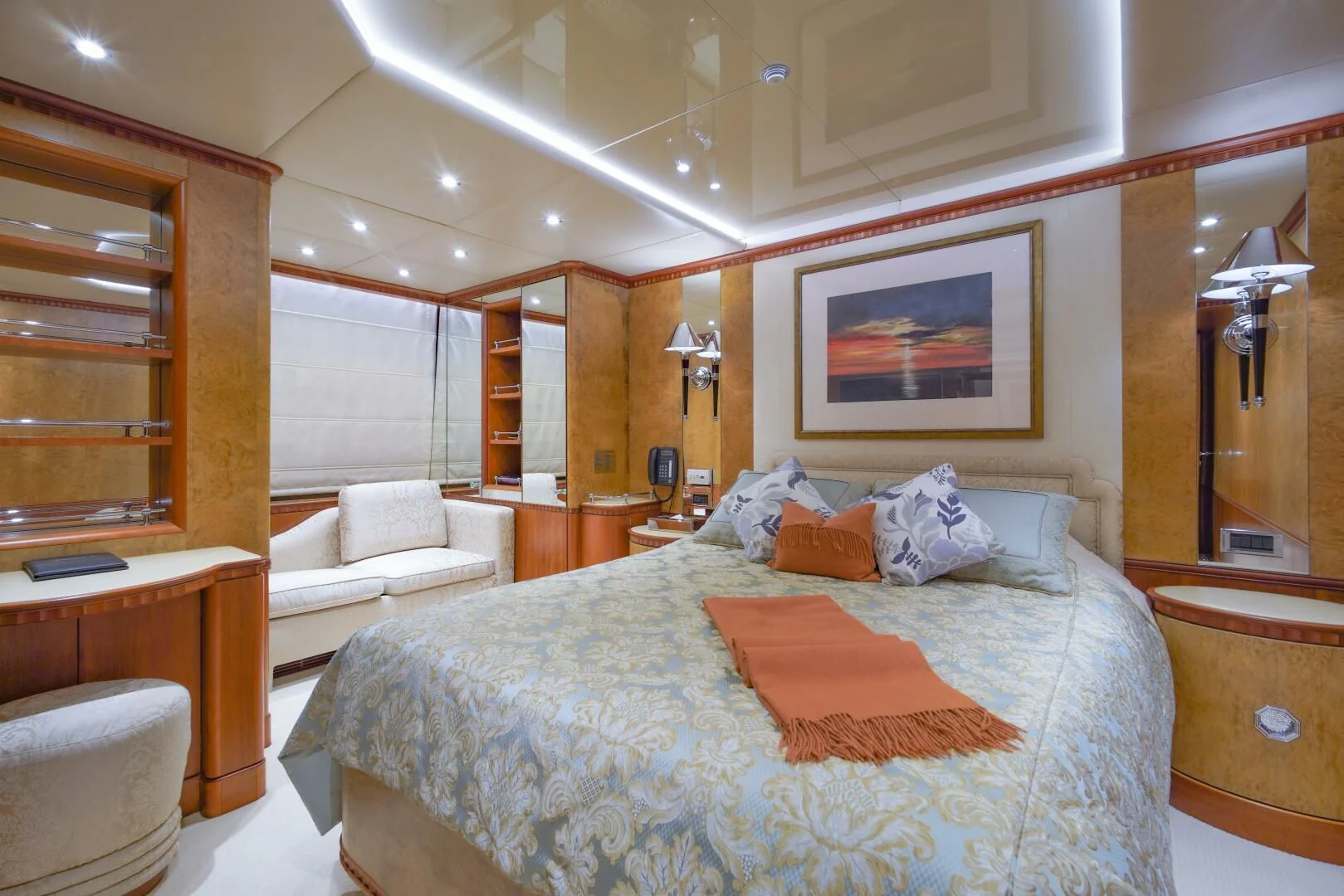 a bedroom with a bed and a mirror aboard AZUL V Yacht for Charter