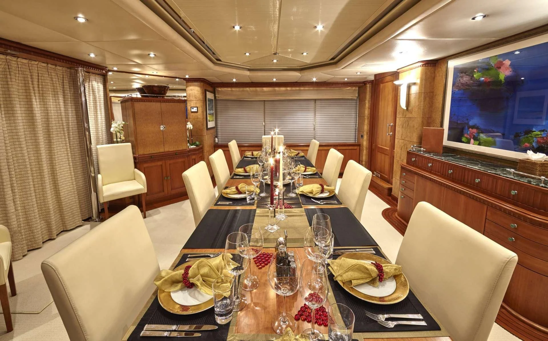 a dining room with a table set for a dinner aboard AZUL V Yacht for Charter