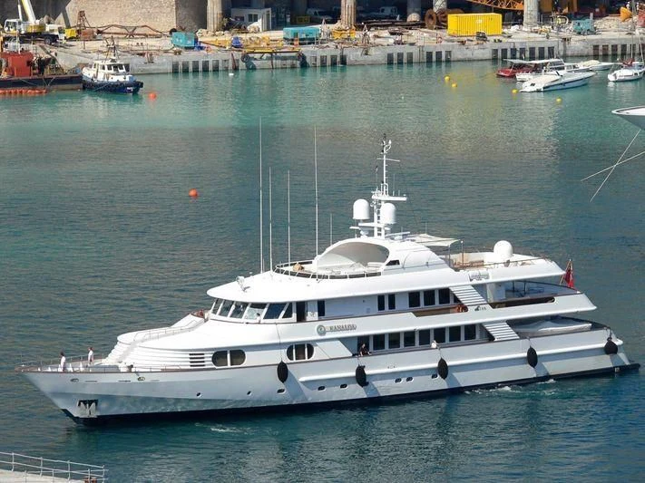 a white yacht in a harbor aboard AZUL V Yacht for Charter