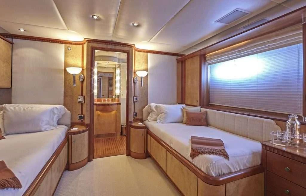 a bedroom with a bed and a mirror aboard AZUL V Yacht for Charter