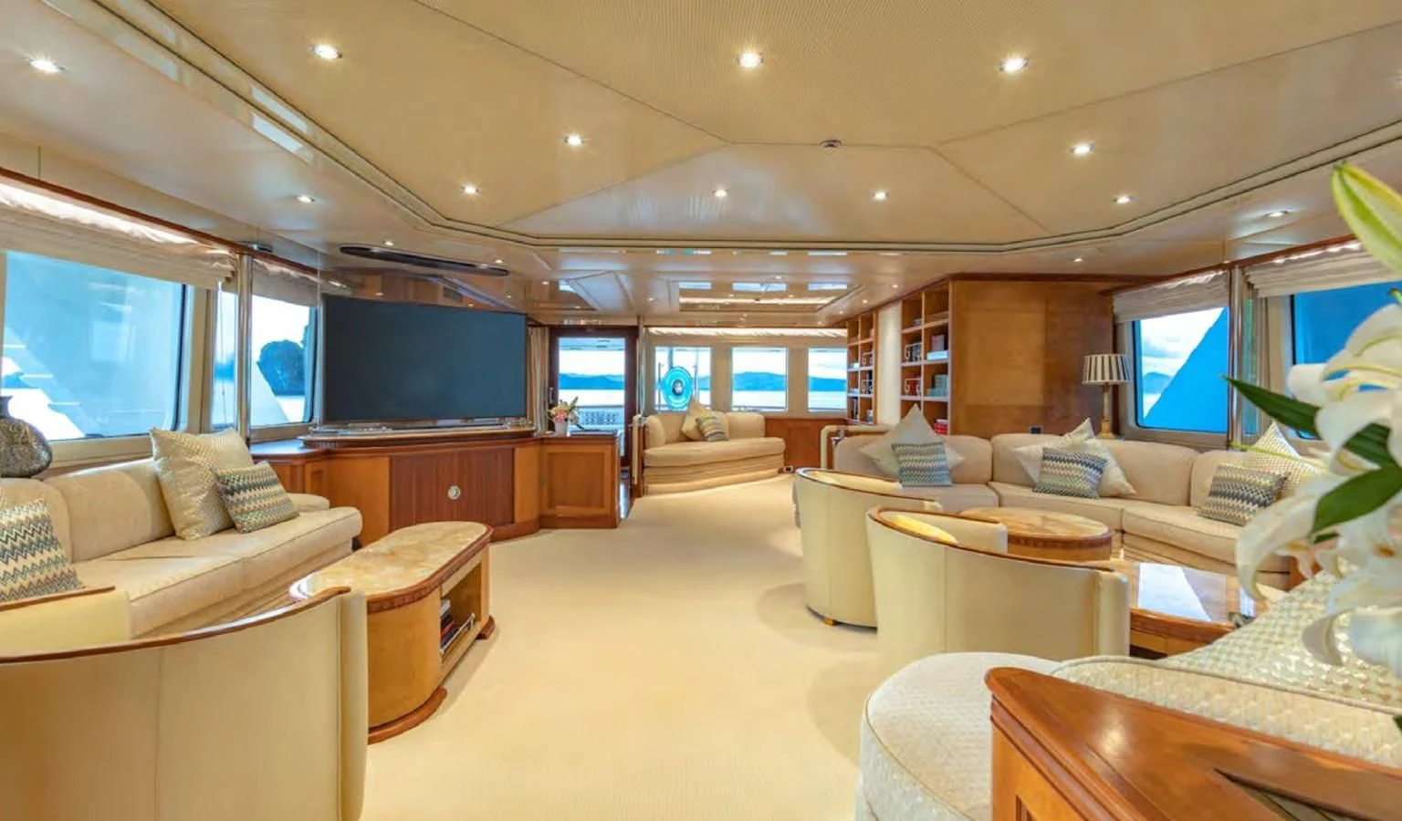 a living room with a large screen aboard AZUL V Yacht for Charter