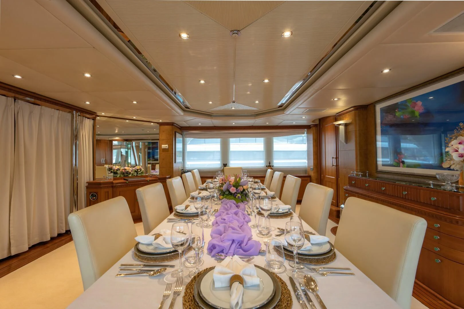 a dining room with a table set for a formal dinner aboard AZUL V Yacht for Charter