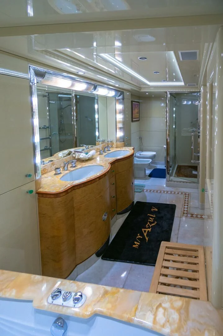 a bathroom with a sink and a mirror aboard AZUL V Yacht for Charter