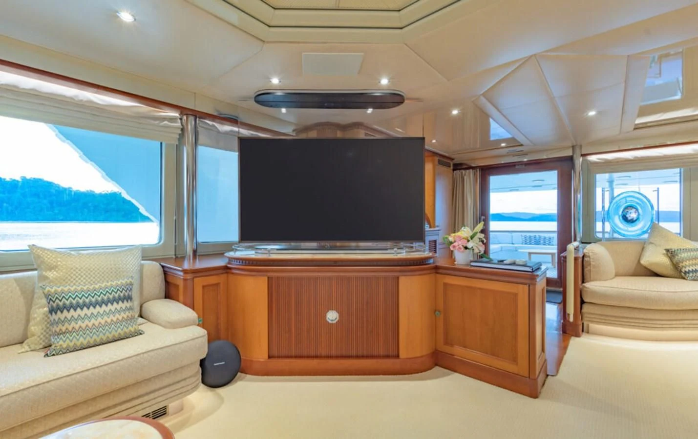 a living room with a tv and furniture aboard AZUL V Yacht for Charter