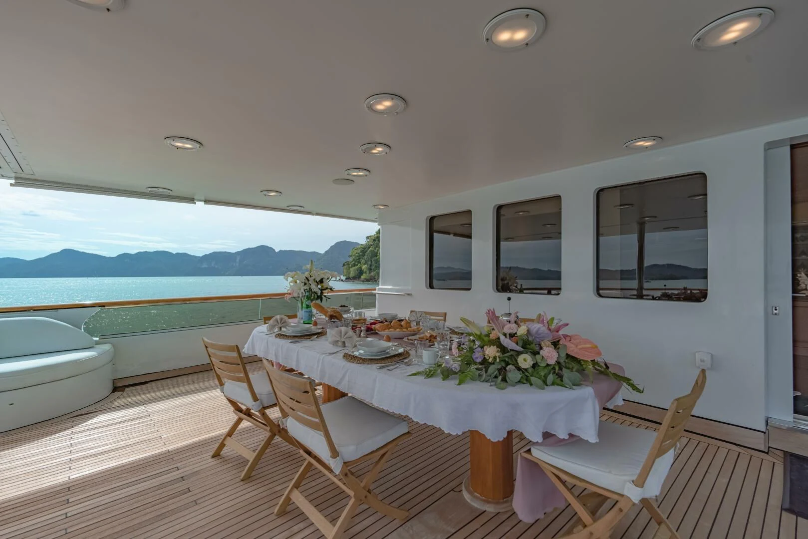 a dining table on a deck overlooking the ocean aboard AZUL V Yacht for Charter