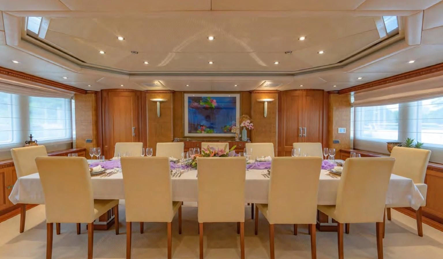 a room with tables and chairs aboard AZUL V Yacht for Charter