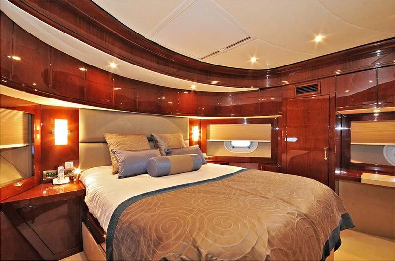 a bed with a white comforter aboard M.T. TIME Yacht for Sale