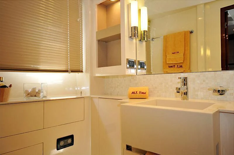 a bathroom with a sink and a mirror aboard M.T. TIME Yacht for Sale