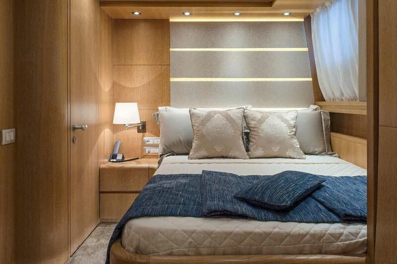 a bed with a blue comforter aboard AMAYA Yacht for Sale