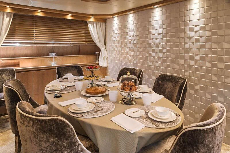a table with plates and food on it aboard AMAYA Yacht for Sale