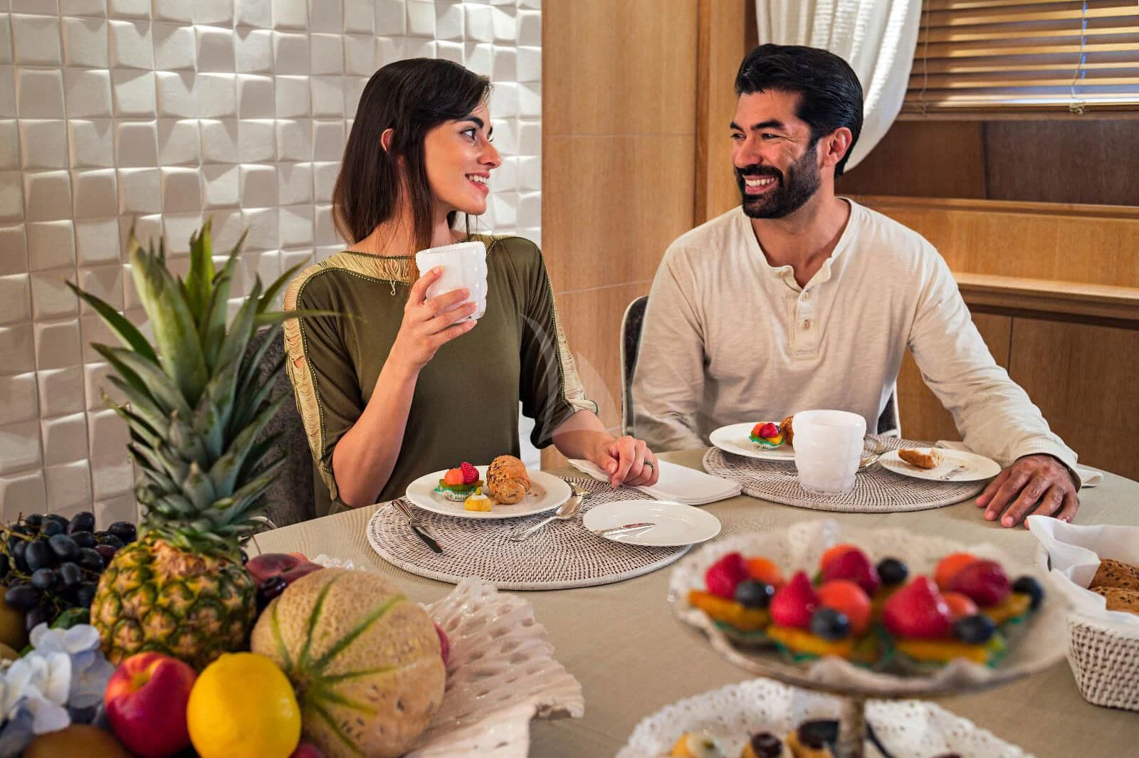 a man and woman eating at a table aboard AMAYA Yacht for Sale