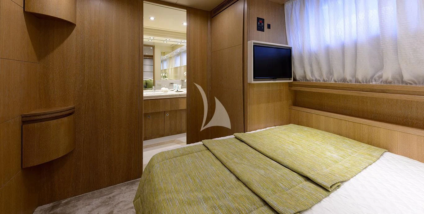 a room with a bed and a tv aboard AMAYA Yacht for Sale