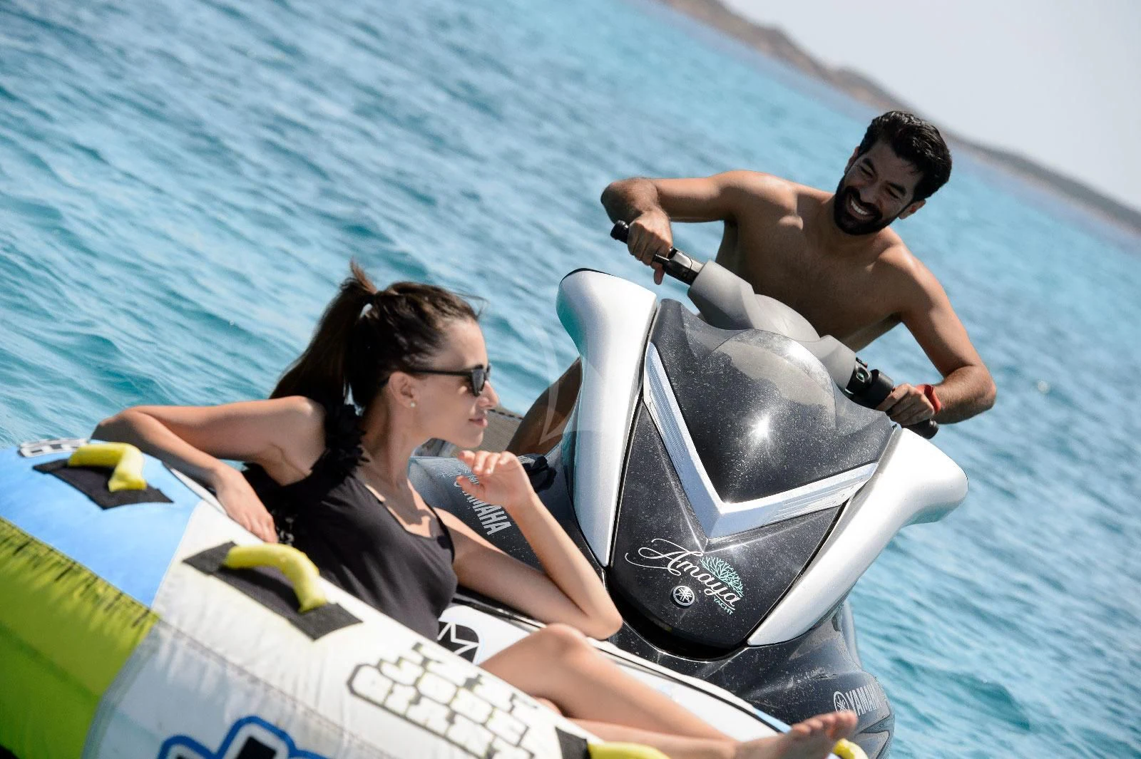 a man and woman in a speed boat aboard AMAYA Yacht for Sale