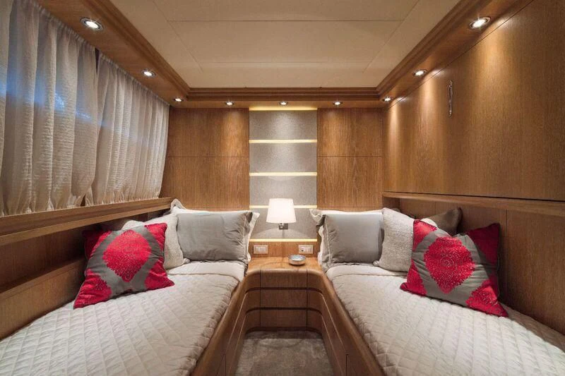 a room with a bed and a table aboard AMAYA Yacht for Sale