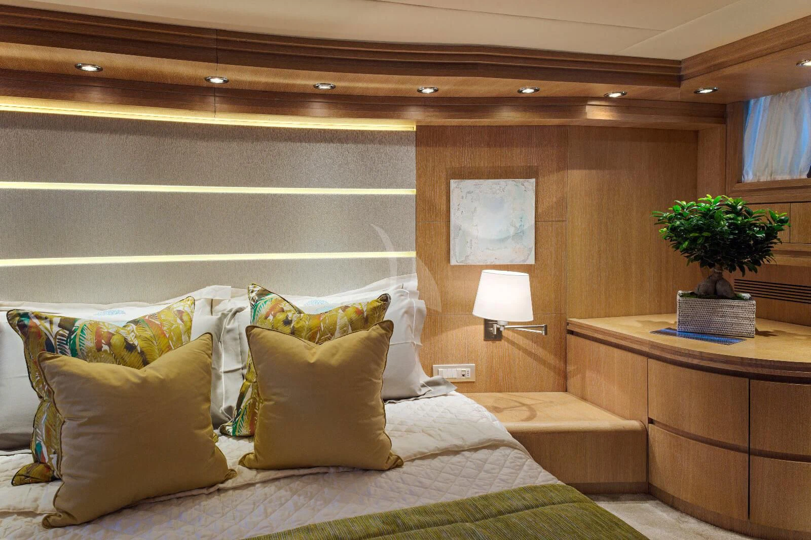 a bed with pillows and a plant aboard AMAYA Yacht for Sale