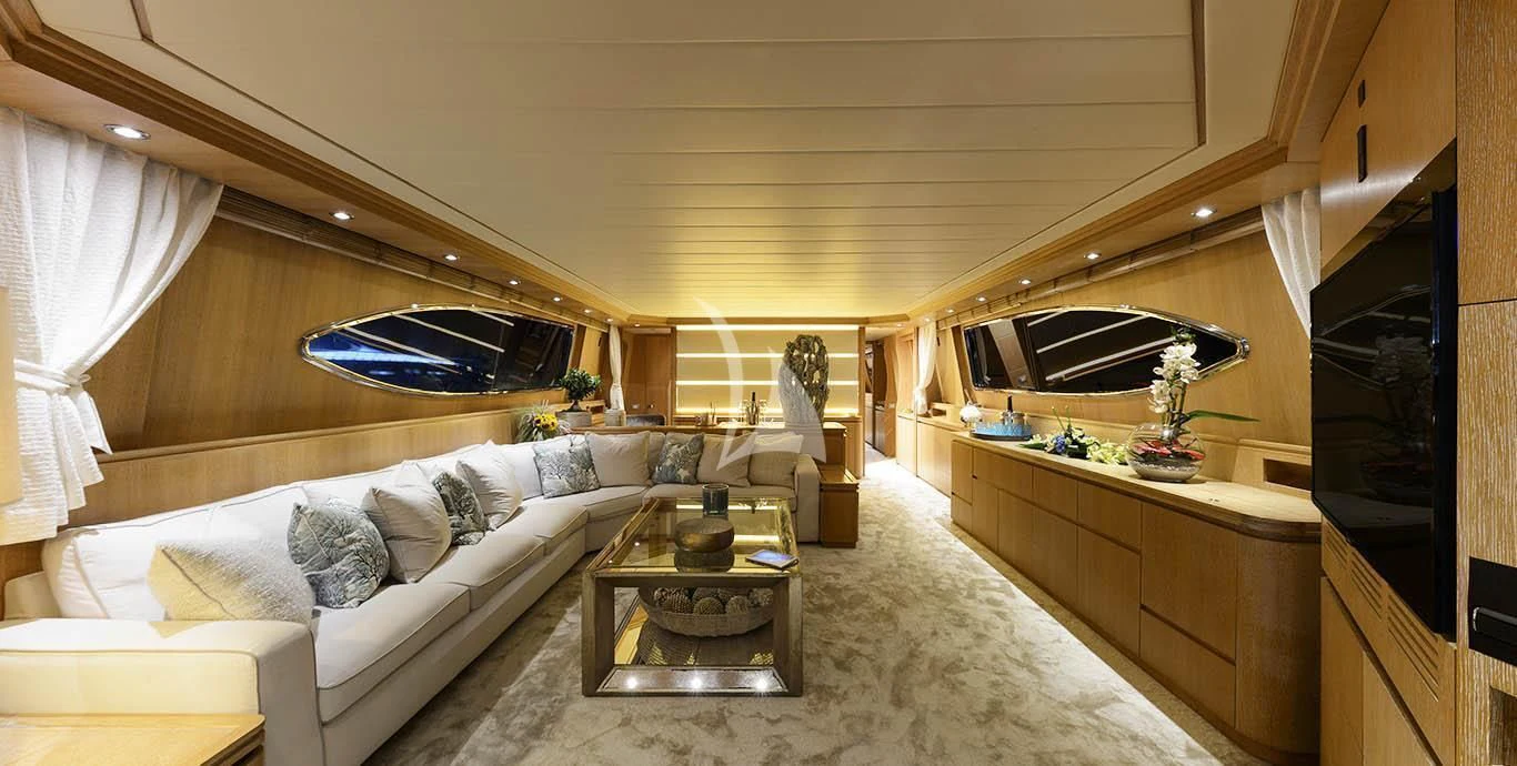 a living room with a couch and a television aboard AMAYA Yacht for Sale