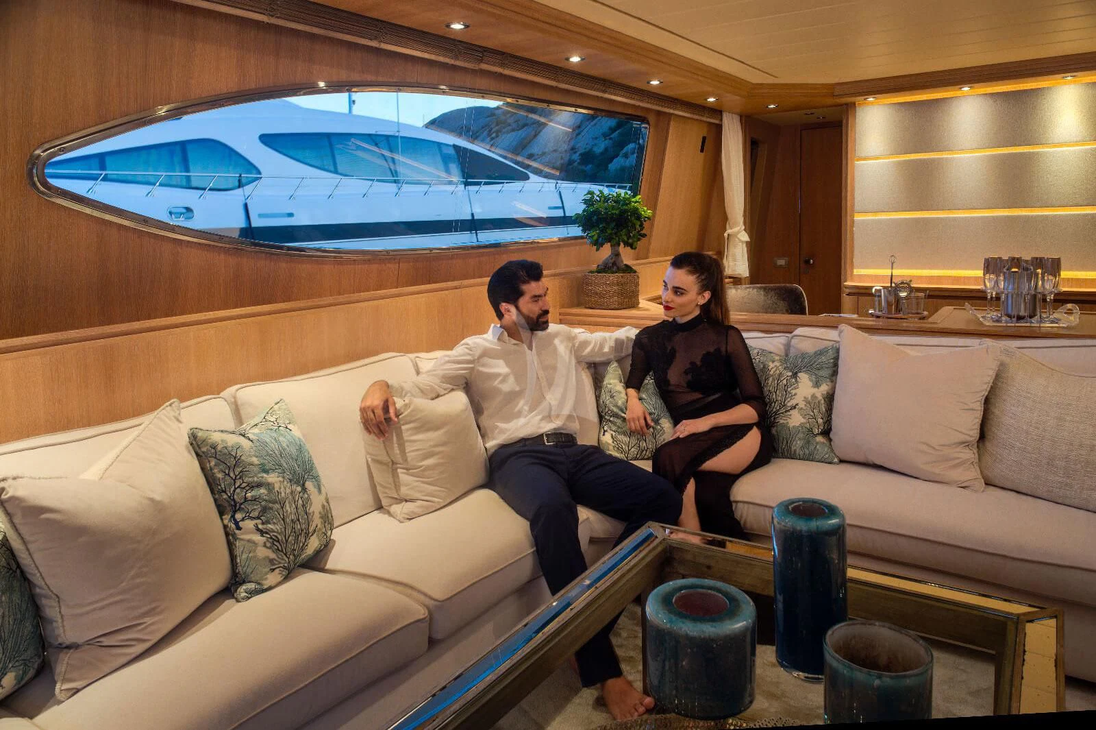 a couple sitting on a couch aboard AMAYA Yacht for Sale
