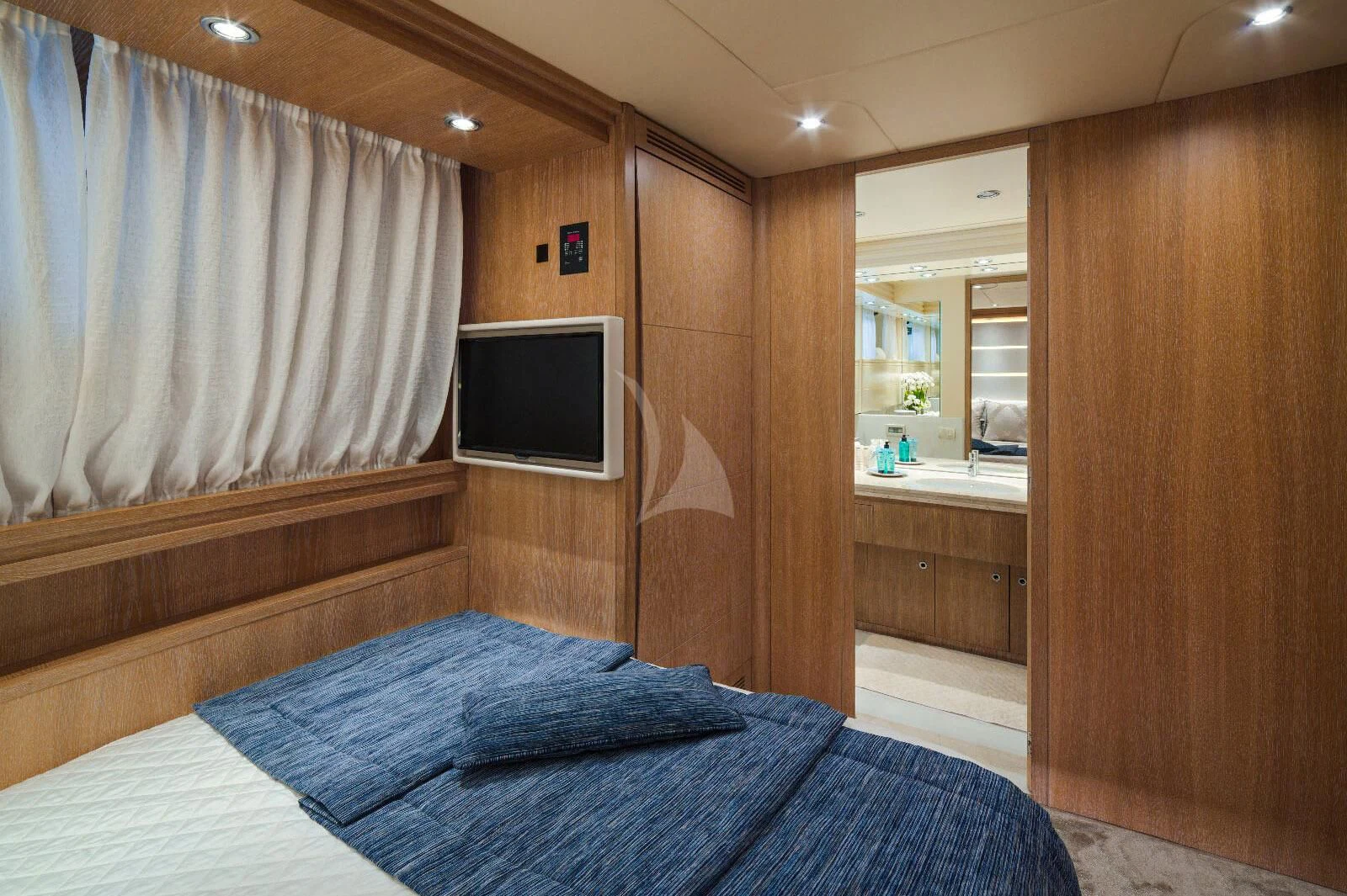 a bedroom with a bed and a television aboard AMAYA Yacht for Sale