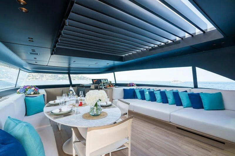 a room with a table and chairs aboard PANAME Yacht for Sale