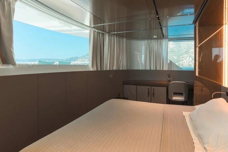 a room with a bed and a desk aboard PANAME Yacht for Sale