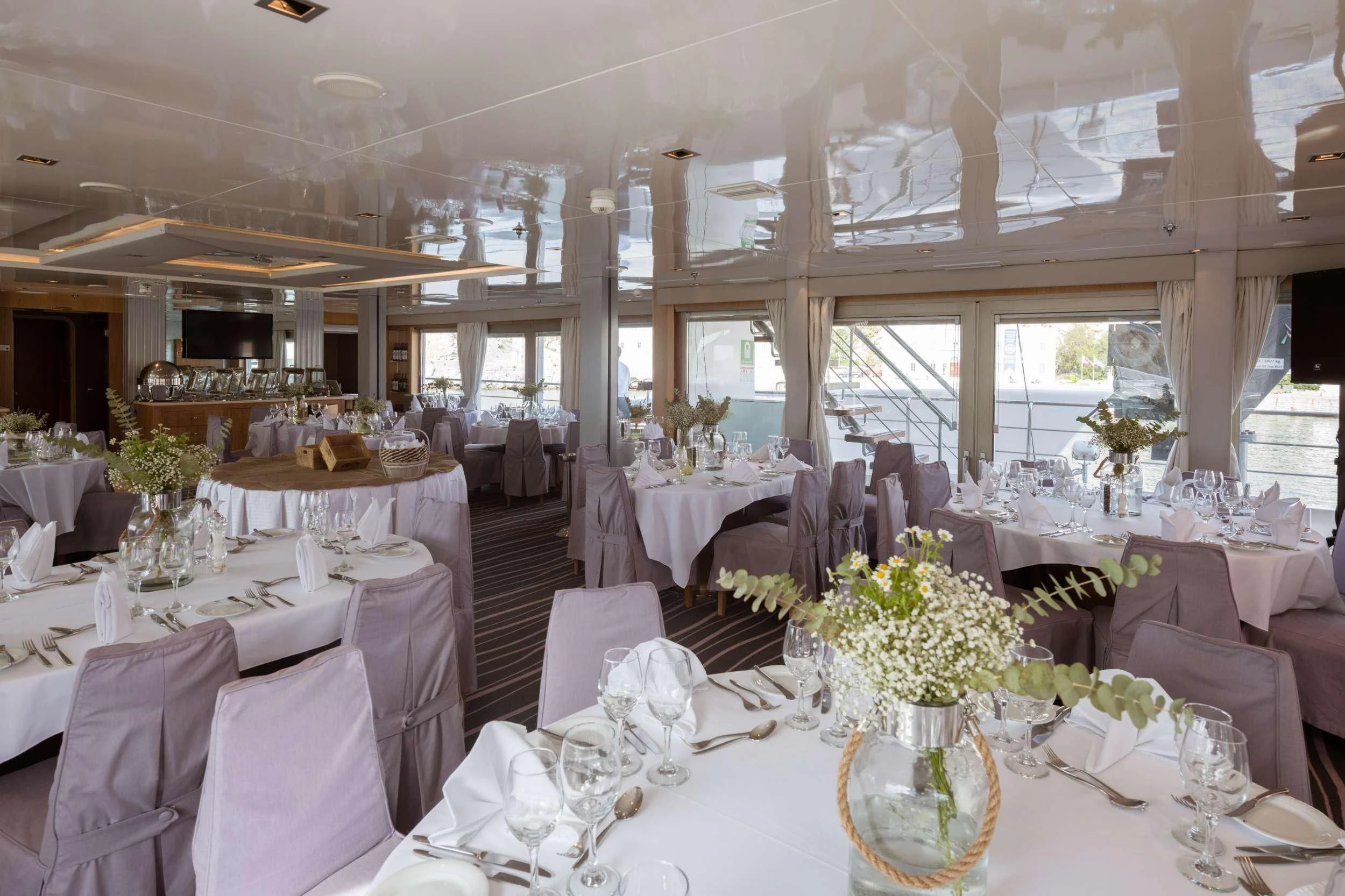 a room with tables and chairs aboard VARIETY VOYAGER Yacht for Sale