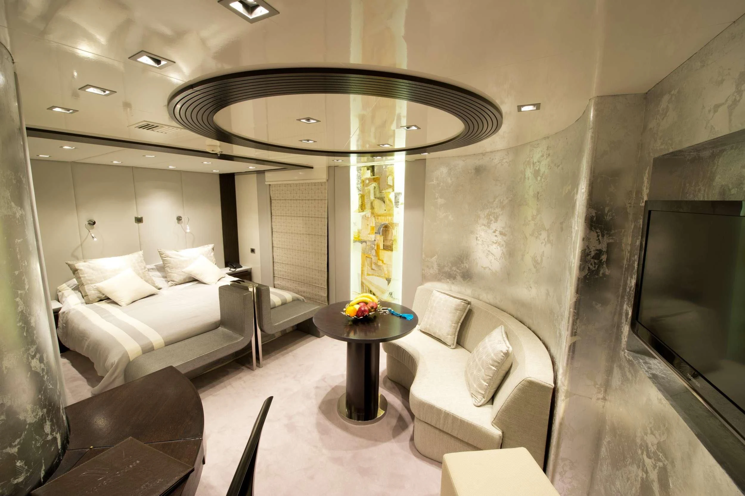 a room with a couch and a table aboard VARIETY VOYAGER Yacht for Sale