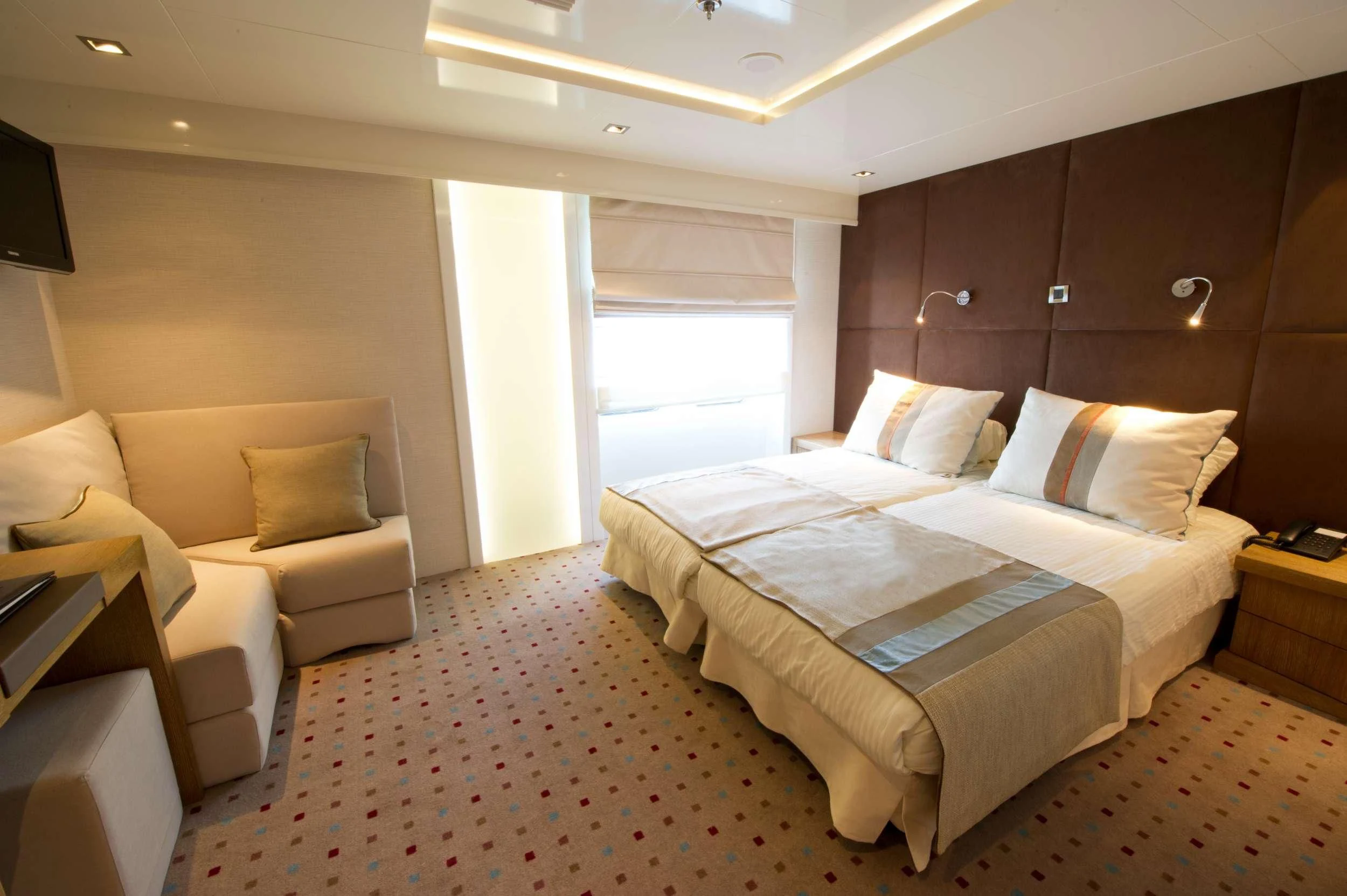 a room with a bed and a couch aboard VARIETY VOYAGER Yacht for Sale